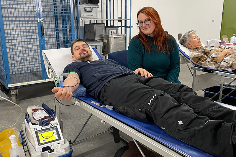 Two donors on a lounger, with a carer in between.